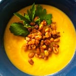 yellow soup with roasted white beans and green parsley