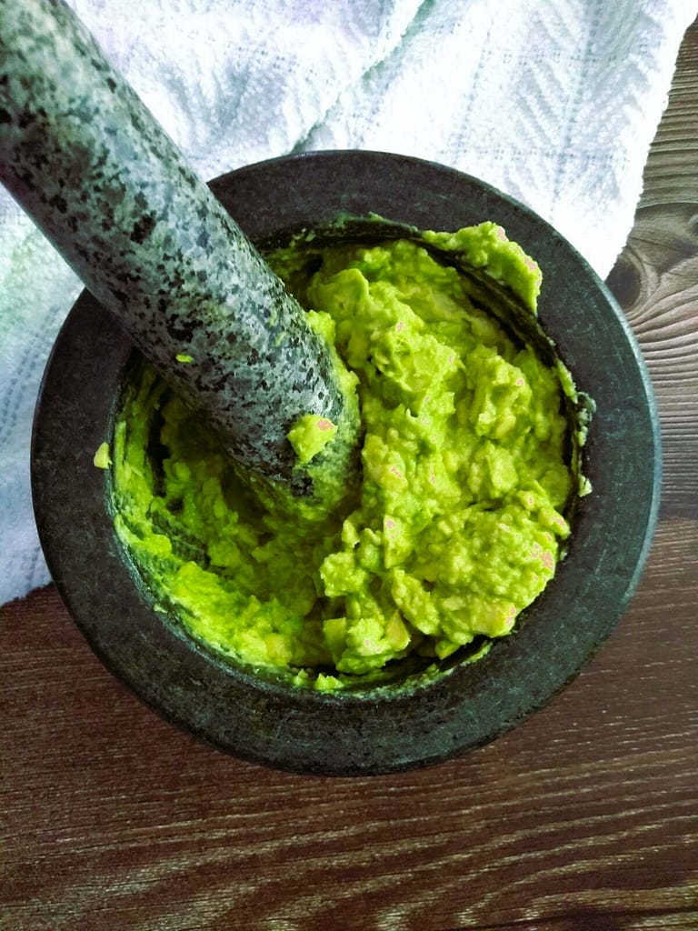 freshly mashed avocado in mortar