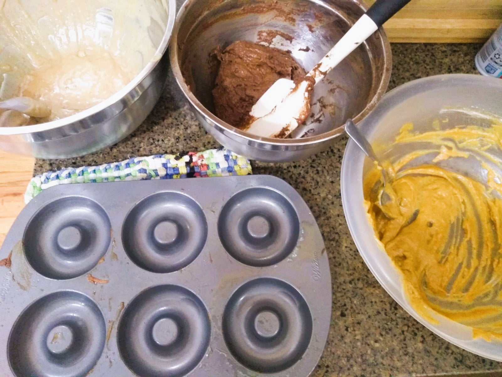 cider, pumpkin spice, and chocolate doughnut batter ready to go in the doughnut pan